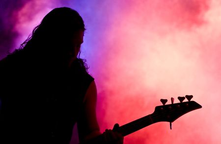 Silhouette of a guitar player live on stageの写真素材