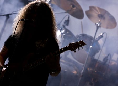 Silhouette of a guitar player live on stageの写真素材