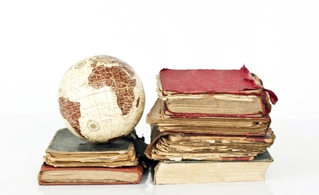 Pile of old books with Earth globeの写真素材