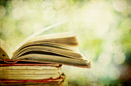 Vintage photo of old books on colorful bokeh backgroundの写真素材