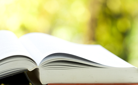Close up on opened book against colorful bokeh backgroundの写真素材