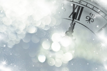 Retro clock New Year's at midnight and holiday lights 