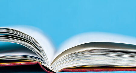 Open book in front of blue 