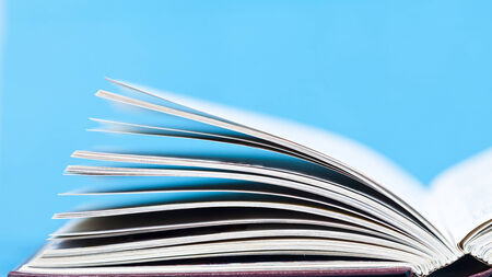 Open book in front of blue 