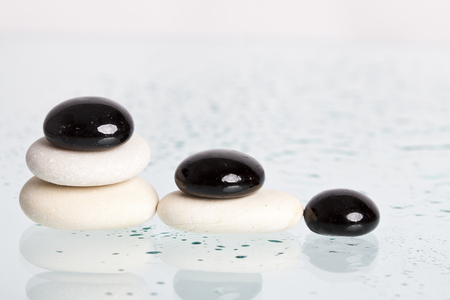 Black and white spa stones with reflectionの写真素材
