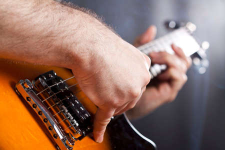 Man playing  electric guitar is studio