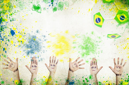 Cheering hands, soccer ball and the colors of the Brazil flagの写真素材