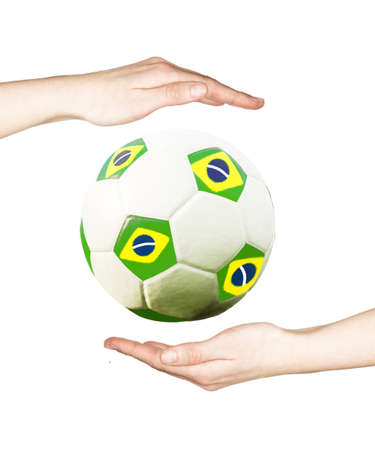 Hands holding soccer ball with the colors of Brazil flagの写真素材