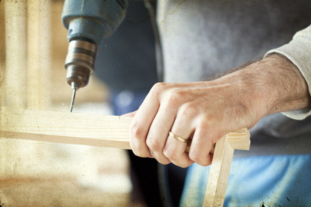 Man s arms drill lath in the workshopの写真素材