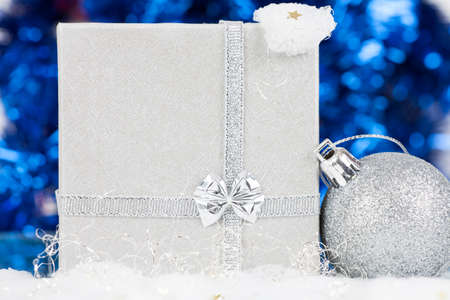 Silver Christmas background with Christmas ball and gift boxの写真素材