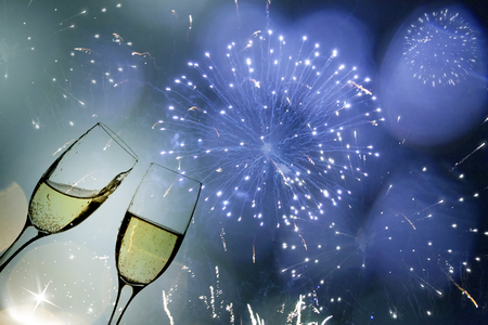 Glasses with champagne against fireworksの写真素材