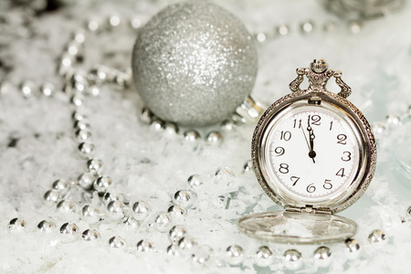 Old silver clock close to midnight and sparkling Christmas decoration - New Year conceptの写真素材