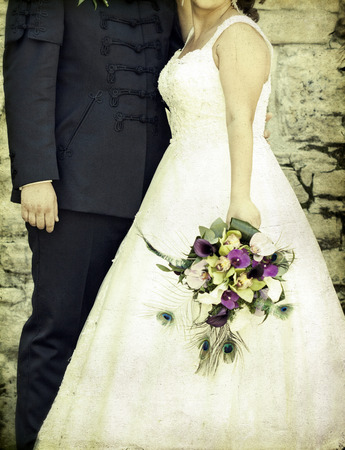 Vintage photo of a groom and a bride holding a wedding bouquetの写真素材