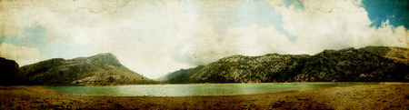 Summer landscape panorama with mountains and cloudsの写真素材