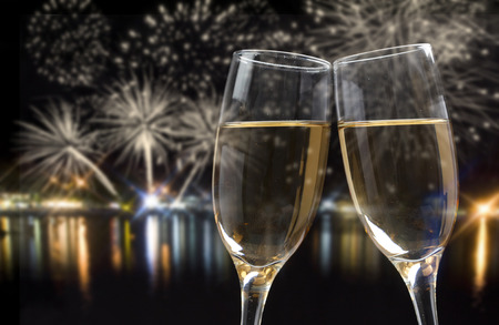 Glasses with champagne against fireworks and city lights Glasses with champagne against fireworks and city lights