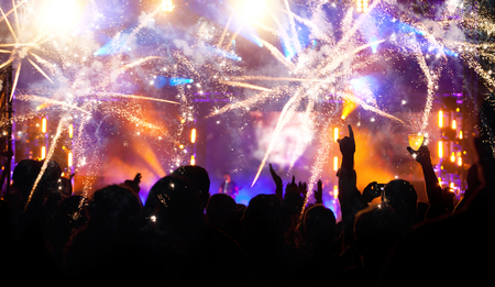 Cheering crowd and fireworks at New Year's Eveの写真素材