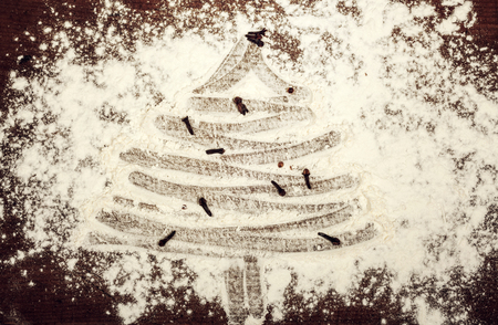 Fir tree made from flour on dark table - Christmas preparations conceptの写真素材