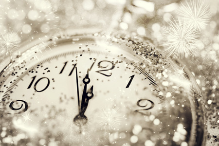 New Year's at midnight - Old watch with stars, snowflakes and holiday lights