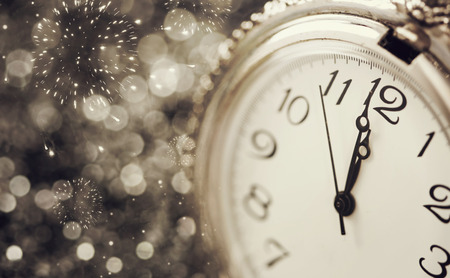New Year's at midnight - Old watch with stars, snowflakes and holiday lights