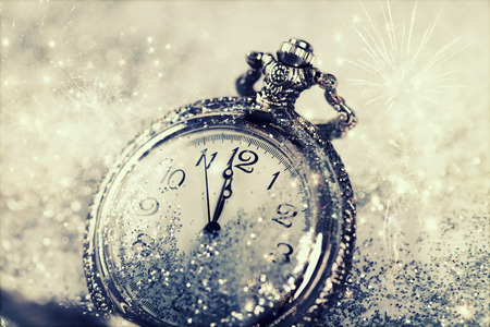 New Year's at midnight - Old watch with stars, snowflakes and holiday lights