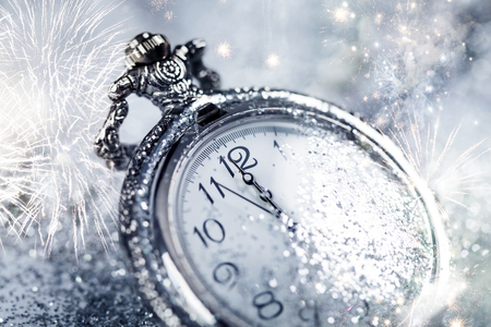 New Year's at midnight - Old watch with stars, snowflakes and holiday lightsの写真素材