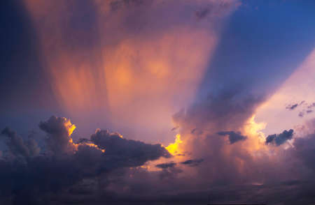 Dramatic sunset sky with orange colored clouds