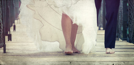 Bride and groom's feet walking barefootの写真素材