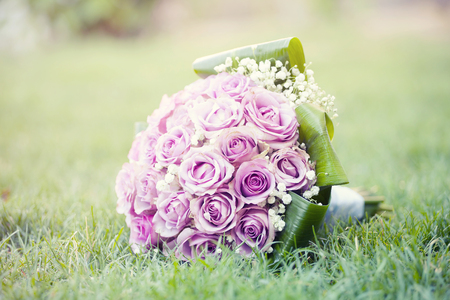 Wedding bouquet of pink roses lying on the groundの写真素材