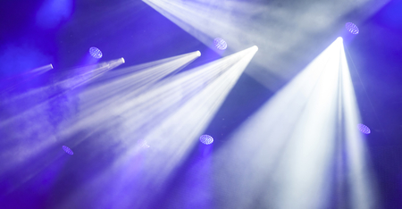 Stage lights on electric concert on blue background