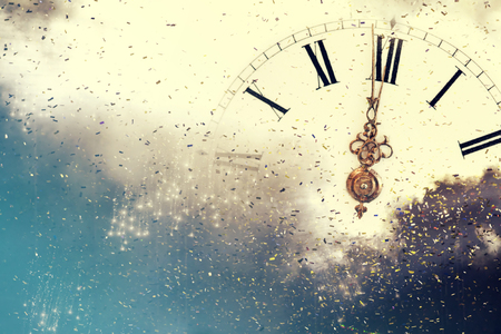 Background of holiday lights and clock close to midnightの写真素材