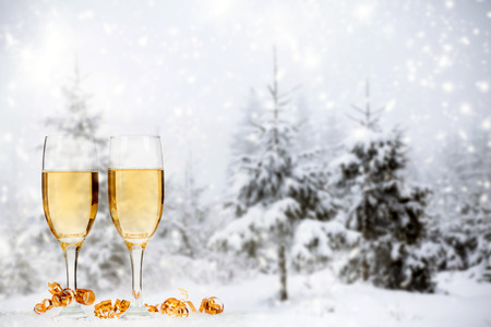 Christmas decorations in front of snow cowered winter backgroundの写真素材