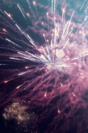 Abstract holiday background with colorful fireworks on the sky