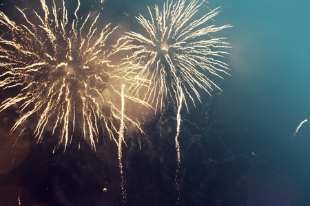 Abstract holiday background with colorful fireworks on the skyの写真素材