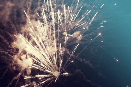 Abstract holiday background with colorful fireworks on the skyの写真素材