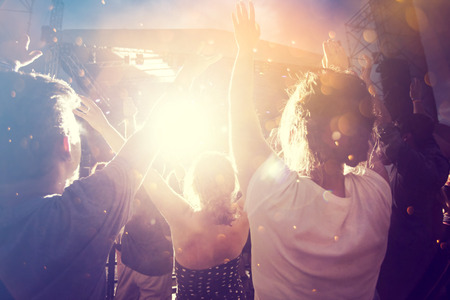 Photo of many people enjoying rock concert, audience applauding to musician band, night entertainment, music festival, happy youth, luxury partyのeditorial素材