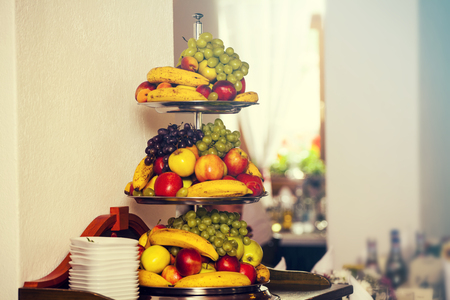 Fruits arrangement. Fresh various fruits elegant decoration.Wedding decoration with fruits in restaurant.の写真素材