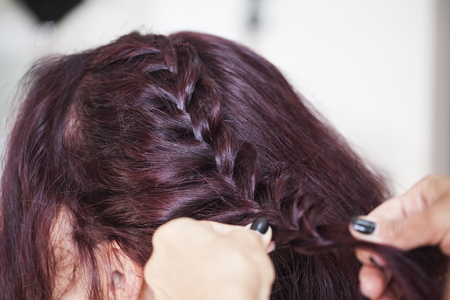Closeup portrait of bridal morning preparation ceremony. Hair stylist makes the bride a wedding...
