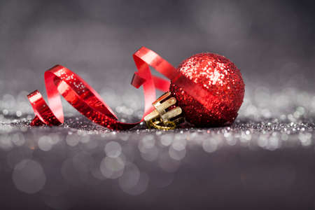 Sparkling Christmas background with red baublesの写真素材