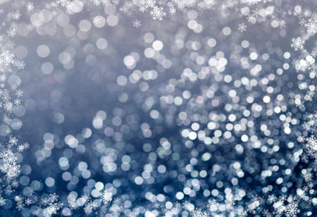 Magic blue holiday abstract glitter background with blinking stars and falling snowflakes. Blurred bokeh of Christmas lights.の写真素材
