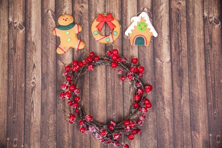 Christmas gingerbread and Christmas wreath on rustic wooden background. Christmas and New Year...