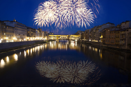 Explosive fireworks around Ponte Vecchio on River Arno - Celebrating New year's eve in Florence, Italyの写真素材