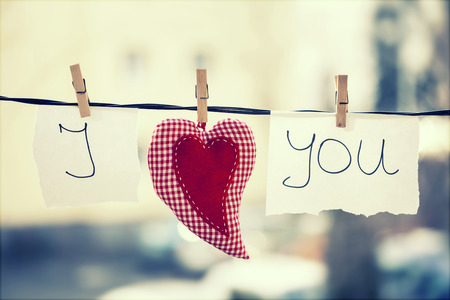 I Love You vintage background. Heart and note with words "I Love You" hanging on a clotheslineの写真素材