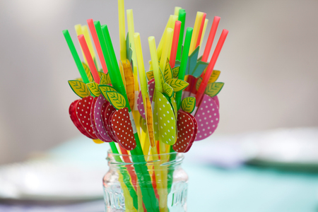 Birthday party table with colorful strawsの写真素材