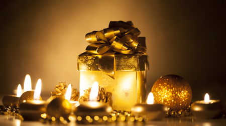 Golden Christmas ornaments and candlesの写真素材