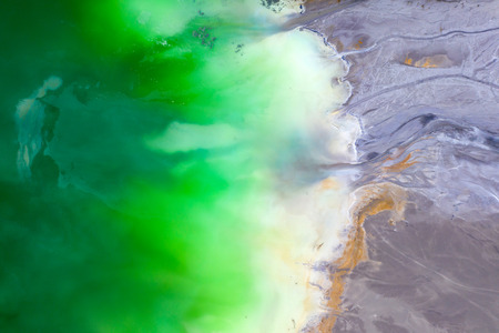 Beautiful aerial pattern of colorful water and mud, shot with a drone located at Geamana, Romania, a...