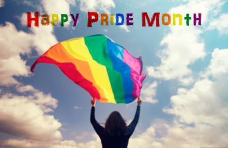 Woman holding a Gay Rainbow Flag over blue summer sky. Bisexual,gay, lesbian, transsexual symbol. Happiness, freedom and love concept for same sex couplesの写真素材