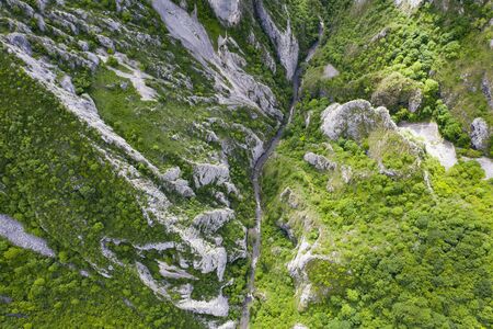 Aerial drone view of Cheile Turzii / Turzii's Gorge canyon, large natural preserve with marked trails for scenic gorge hikes crossing streams & bridges.の写真素材