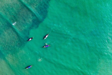 Aerial, drone view of turquoise clear water and longtail boats near Krabi, Thailandの写真素材