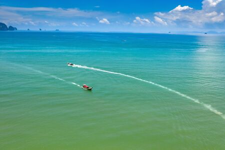 Aerial, drone view of turquoise clear water and longtail boats near Krabi, Thailandの写真素材