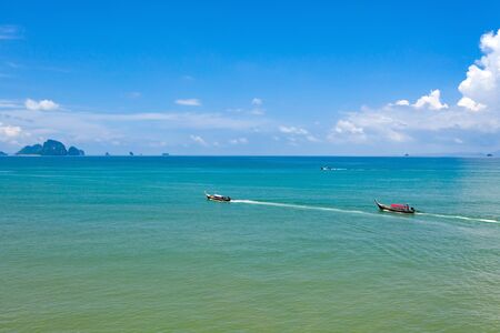 Aerial, drone view of turquoise clear water and longtail boats near Krabi, Thailandの写真素材